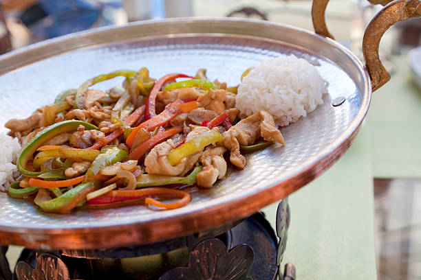 chinese chicken meal in copper pan stock photo