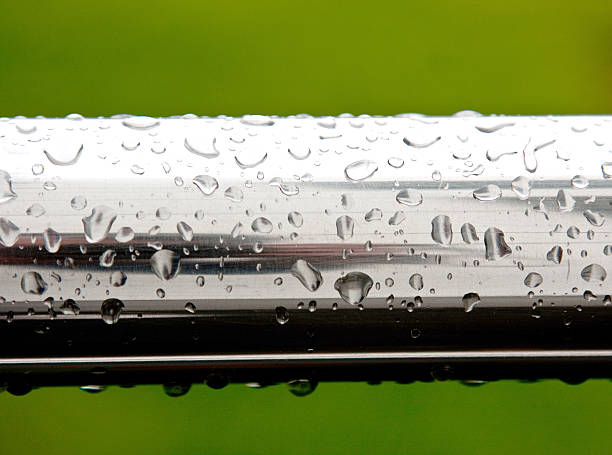 Rain drops on chrome surface stock photo