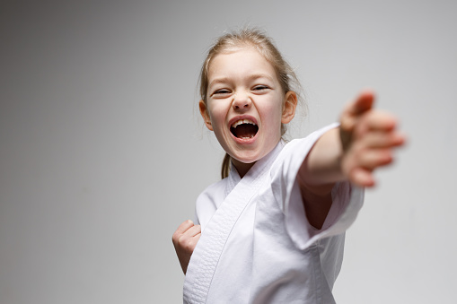 Hand punch in karate, self-defense of a little girl.