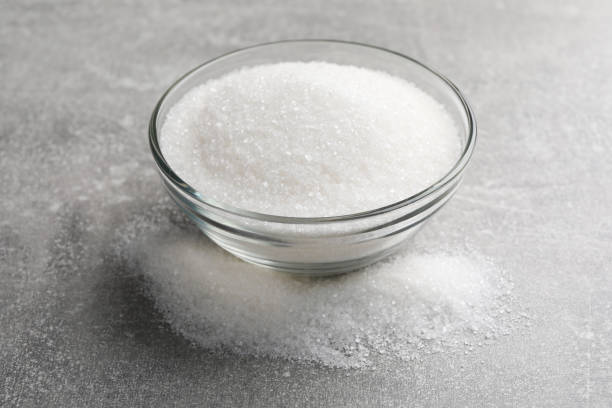 istock Granulated sugar and glass bowl on light grey table, closeup 1467953188