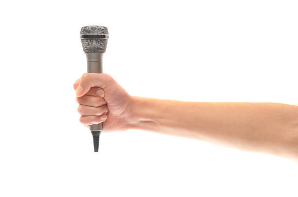 istock Hand and arm holding microphone isolated on white 146795467