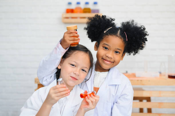 Child in classroom at school, Kid dressed Science lab coat. Science concept