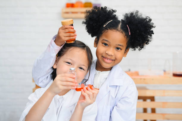 istock Child in classroom at school, Kid dressed Science lab coat. Science concept 1467958540