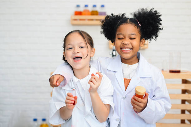 istock Child in classroom at school, Kid dressed Science lab coat. Science concept 1467958731