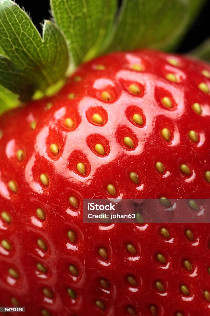 A close-up of a ripe red strawberry Close-up detail of a fresh red strawberry with leaves Antioxidant Stock Photo