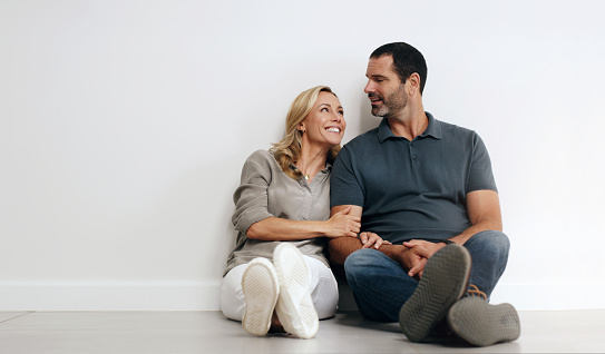New home, couple relax on wall mockup space and floor happy for real estate, property investment and life together. Mature people or woman with partner thinking of success, apartment or house in love