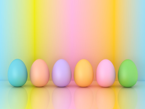 Easter three colorful yellow, pink and blue chicken eggs isolated on white background.