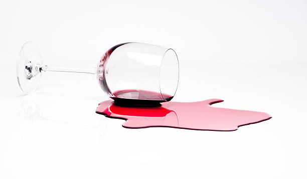 Spilled Red Wine Some Red Wine being poured / spilled. wine glass knocked over stock pictures, royalty-free photos & images