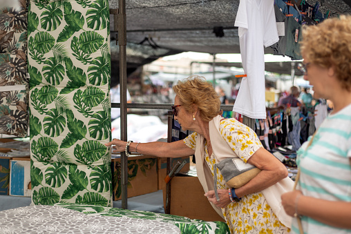 Two elderly women at a street market