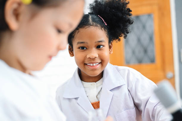 istock Child in classroom at school, Kid dressed Science lab coat. Science concept 1467962633