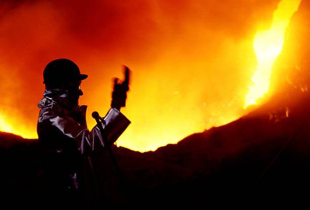 Steelmaker in front of a volcano stock photo