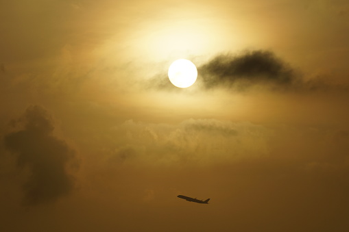 Golden Yellow Sunrise sky with aircraft taking off