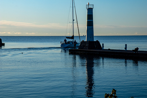 A sailboat passed a pier