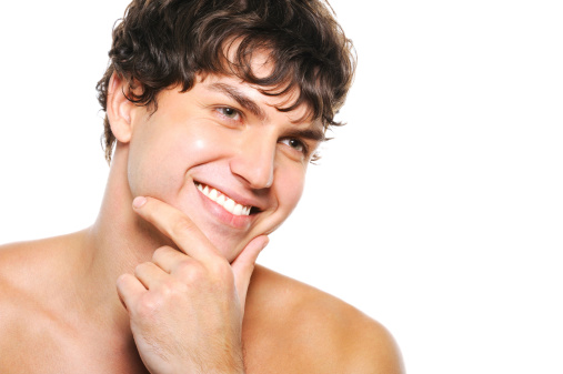Portrait of handsome young man with clean-shaven face and happy smile