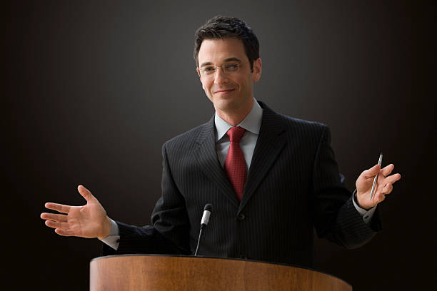 istock A businessman lecturing at a podium 146796618