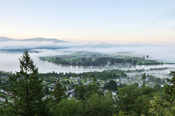 Fraser Valley at foggy sunrise Fraser Valley at foggy sunrise, British Columbia, Canada abbotsford canada stock pictures, royalty-free photos & images