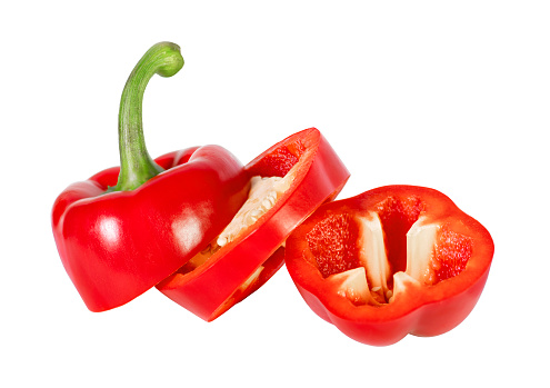 Red bell pepper cut into three pieces isolated on white background