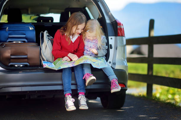 istock Two adorable little sisters exploring a map before going on vacations with their parents 1467970791