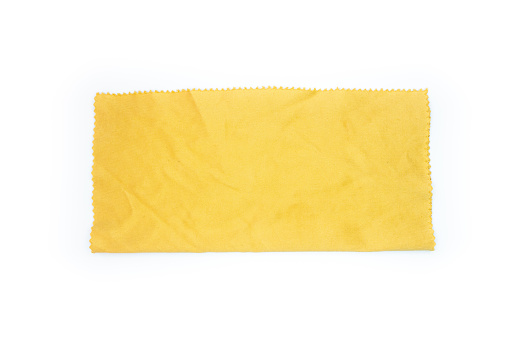 Yellow eye glass or lens cloth isolated on a white background. Top view, flat lay.