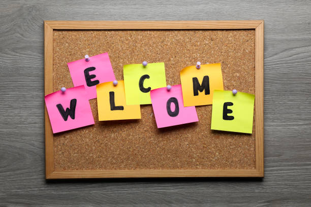 istock Corkboard with word Welcome on wooden table, top view 1467971102