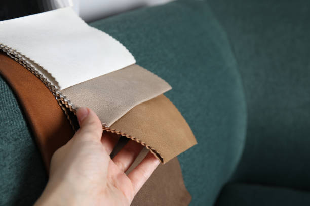 istock Woman choosing fabric among colorful samples on green sofa, closeup. Space for text 1467971129