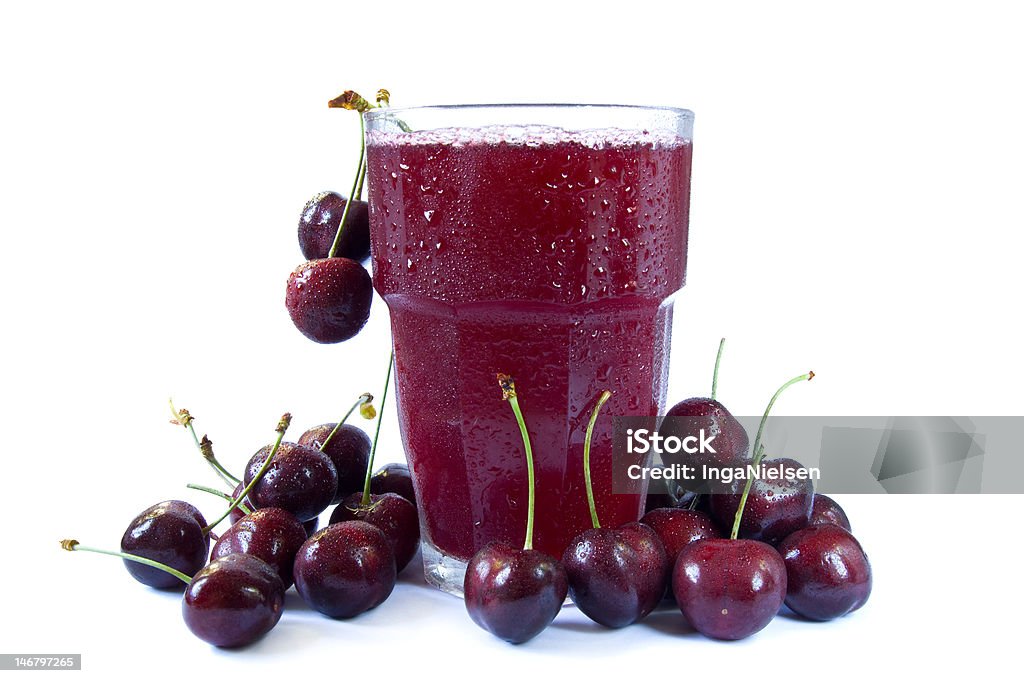 Cherry juice Fresh juice of cherries decorated with red cherries and isolated on white. Cherry Stock Photo