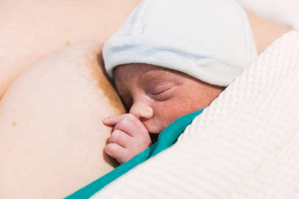 istock Newborn baby sleeping on mother after birth. 1467972964