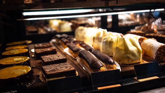 A variety of delicious Indian Bengali Sweets - gulab jamun, rasogulla, kaju barfi, kheer kadam, sandesh and laddu displayed on the street side food stall in Kolkata for sale.