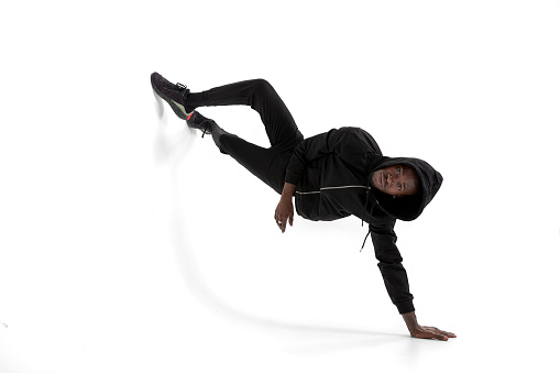 Black man of African descent wearing hooded sportswear. Athlete man doing sporty movements.