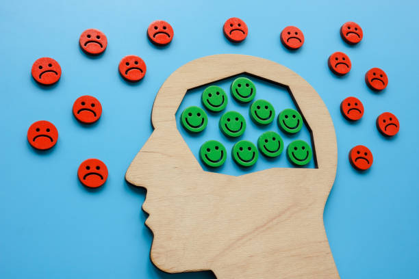 istock Head with smileys and sad emoticons around. Positive attitude and resilience. 1467975945