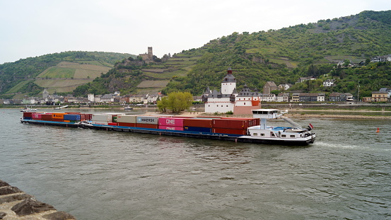 Containers laden barge passing down the River Rhine, Pfalzgrafenstein Castle, on the Falkenau island, in the background, view from the left bank, Kaub, Germany