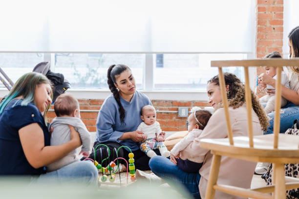 istock Young mom sad in midst of friends group 1467976219