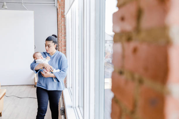 istock Sad mom walks with fussy baby 1467976241