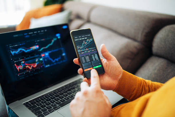 istock Cryptocurrency investor trading at home using his laptop and his phone. 1467976879