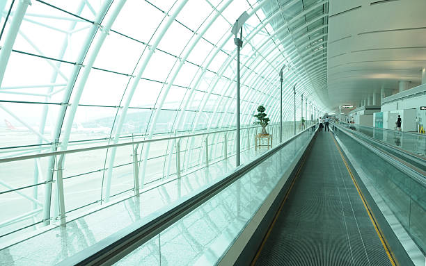 Long airport corridor with escalator stock photo