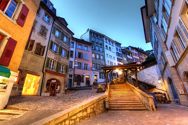 Escaliers du Marche is a steep route coming down from the Cathedral to the Place de la Palud in the historical center of Lausanne, Switzerland. Some of the houses lining up this pedestrian street date back to 13th century, but on the overall the current shape dates back to 1719. Wide angle shot taken shortly after sunset using HDR technique.