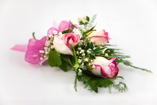 A corsage of fuchsia-tipped sweetheart roses.