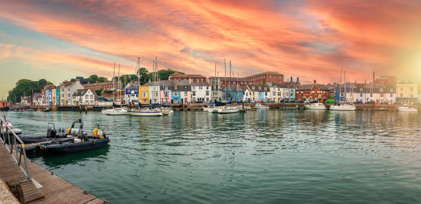 Harbour in town of Weymouth, UK Fishing harbour at sunset in Weymouth, Dorset, UK dorset england stock pictures, royalty-free photos & images