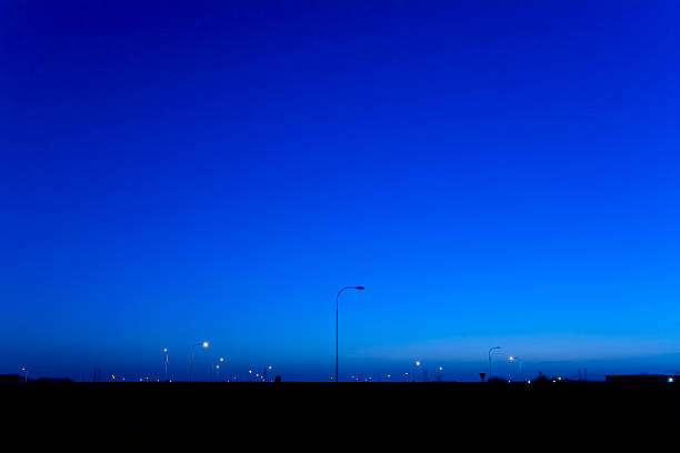 Street lights and power lines shot at dusk. Image recorded on a Canon 1Ds Mark II.