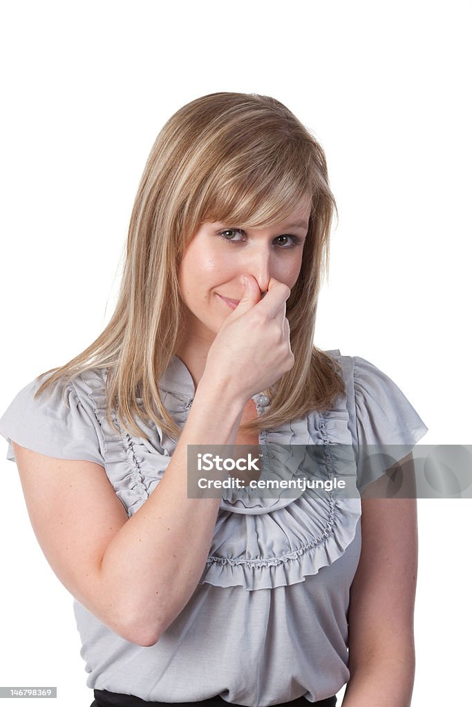 Młoda kobieta ściskając jej nos - Zbiór zdjęć royalty-free (Biznes)