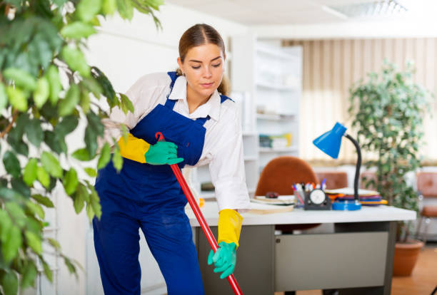 istock Young woman cleaning office 1467985606