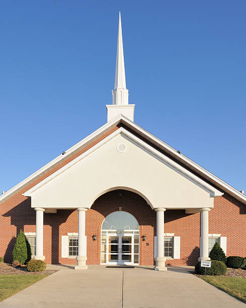 Church with Tall Steeple Christian church with steeple against blue sky baptist stock pictures, royalty-free photos & images