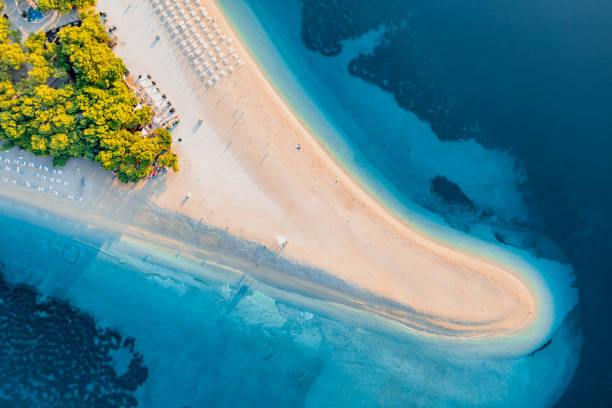 Panoramic aerial view at the Zlatni Rat. Beach and sea from air. Famous place in Croatia. Summer seascape from drone. Travel - image Panoramic aerial view at the Zlatni Rat. Beach and sea from air. Famous place in Croatia. Summer seascape from drone. Travel - image brac island stock pictures, royalty-free photos & images