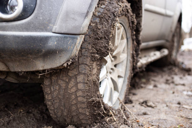 istock SUV wheel soiled with mud. Off-road and bad weather 1467986230