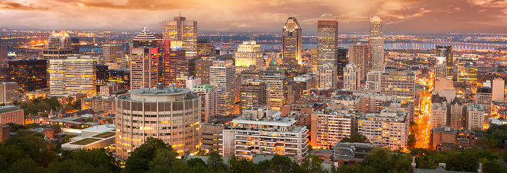 Panoramic view over the skyline of Frankfurt am Main in the evening with illuminated streets of the city center and skyscrapers