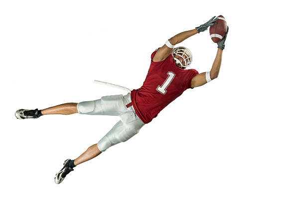 Football Catch On White American football player in action with ball wide receiver athlete stock pictures, royalty-free photos & images