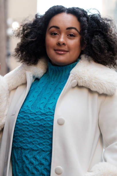 istock A young chubby woman is looking at camera in a cold morning. 1467993744