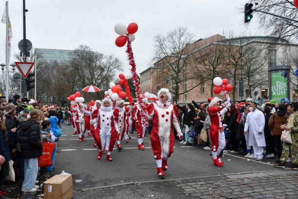 Bad Hindelang, Germany - Februar 14, 2010: Unidentified clown with red hairs, self made clothes and colored ballons participates at the annual public carnival parade through the streets of city Bad Hindelang in southern part of Bavaria.