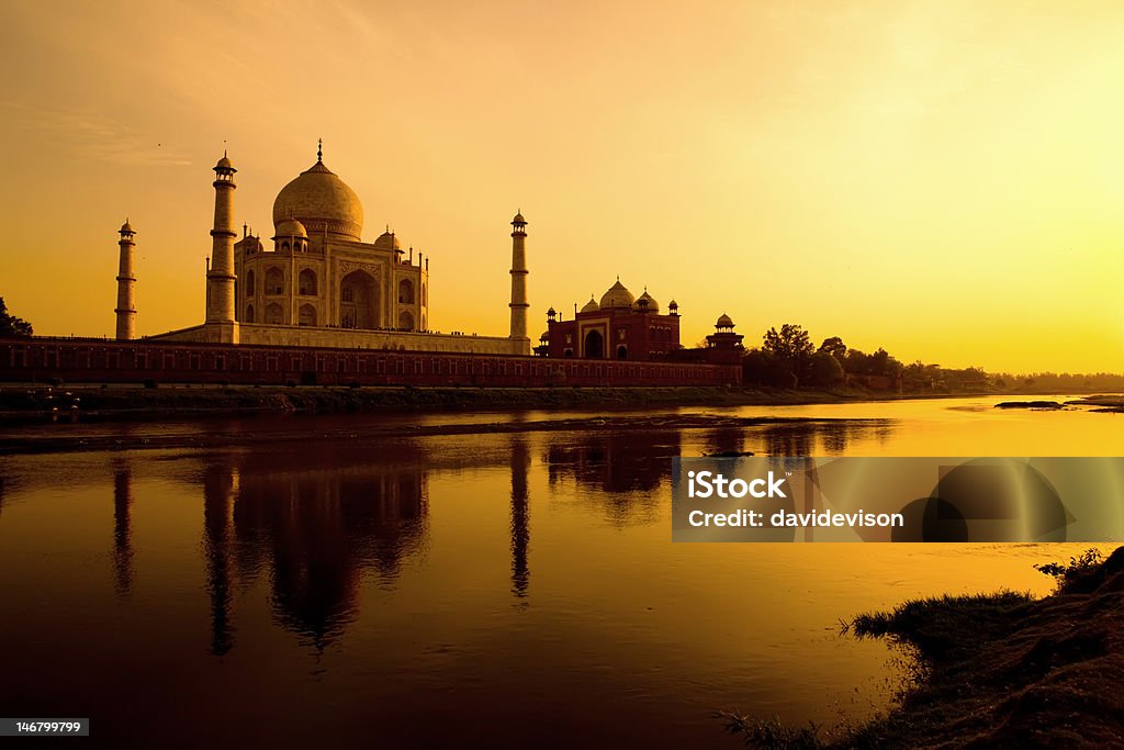 Taj Mahal at sunset refected in the Yamuna river. Taj mahal sunset from the north bank of the Yamuna river. Taj Mahal Stock Photo
