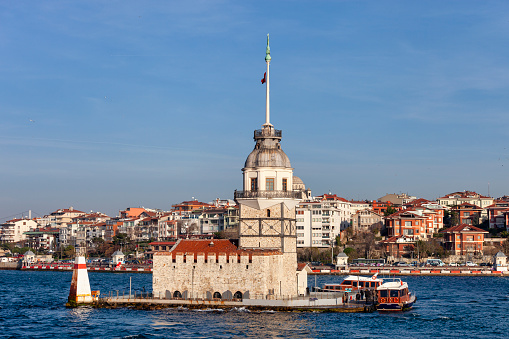 Istanbul,Turkey- Jan 10,2014:Maiden's Tower and Uskudar View. The photo was taken from the ferry. Maiden's Tower is located on a small island on the sea. Maiden's Tower is located on a small island on the sea.